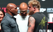 jake paul and mike tyson staring at one another 