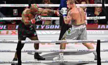 Mike Tyson (in black short) and Jake Paul (in silver short) exchange punches during their heavyweight world titles of the Premiere Boxing Championship