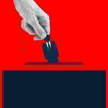 Human hand placing an icon of man wearing suit into the voting box.
