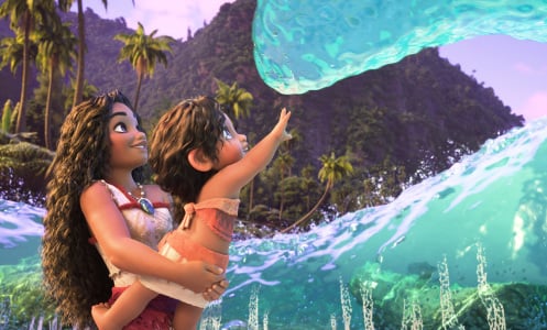 A still from "Moana 2" in which Moana holds her little sister up to a friendly wave in greeting.